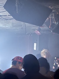 a crowd of people at a concert in a dark room