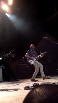 a man playing a guitar on a stage