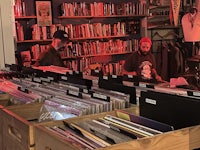 a group of people standing in front of a record store