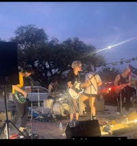 a group of people playing music on a stage