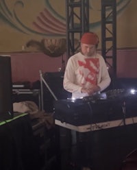 a man in a red hat is playing a dj set