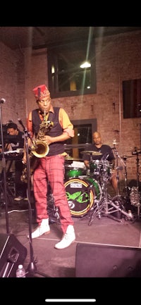 a man playing a saxophone on stage