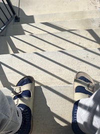 a person standing on a set of stairs in a pair of sandals