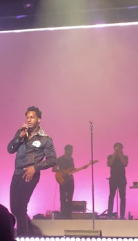 a man on stage singing into a microphone